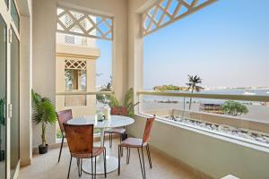 Un balcón con mesa y sillas y vista al mar. en VayK - Beachfront 1BR with Sea Views in Palm Jumeirah, en Dubái