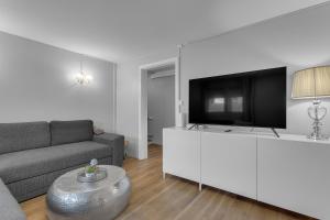 a living room with a couch and a flat screen tv at Castle Inn Apartments - Downtown Keflavík in Keflavík