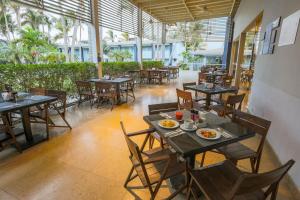 a restaurant with tables and chairs with food on them at Casa Andina Standard Piura in Piura