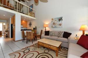 a living room with a couch and a table at Kulakane 304 in Kahana