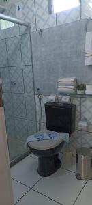 a bathroom with a glass shower and a toilet at Casa de Jovan in Cayru +1 photo