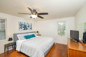 a bedroom with a bed and a ceiling fan at Family Brick House Charm - 4 br 3 bath in Appleton