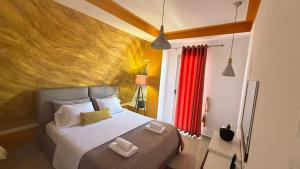 a bedroom with a bed with two towels on it at Your Apartment in Pogradec