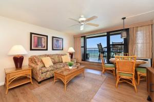 a living room with a couch and a table at Kaleialoha 309 · KA 309 Oceanfront Condo AC Ocean Views Heated P in Kahana