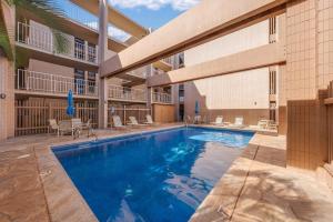 a swimming pool in front of a building at Kaleialoha 309 · KA 309 Oceanfront Condo AC Ocean Views Heated P in Kahana