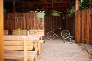 a picnic table and a bike parked in a fence at ante porta DAS STADTHOTEL in Trier