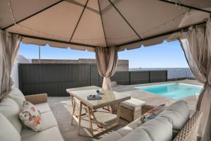 a patio with a table and a pool at Villa Carlota in Garachico
