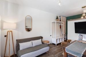 a living room with a couch and a tv at Chalet Elegance in Livigno