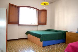 Ένα ή περισσότερα κρεβάτια σε δωμάτιο στο Casa Umi al primo piano per 7 pax