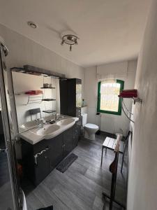a bathroom with a sink and a toilet at Chambres D'hôtes Mongarny Cancale in Cancale