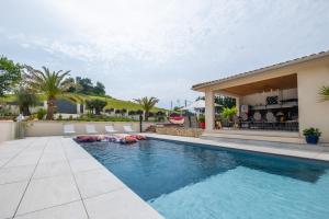 a swimming pool in the backyard of a house at Villa Gurson in Carsac-de-Gurson