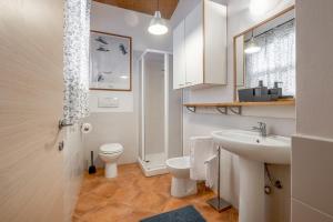 a white bathroom with a sink and a toilet at Sweet Tuscany in Capalbio +50 photos