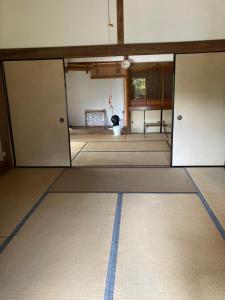 an empty room with two doors and a rug at くりのやかた Kuri no Yakata in Minami-ura +18 photos