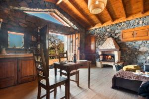 a kitchen and living room with a stone fireplace at Finca Rural House Tenerife Relax in Santa Úrsula