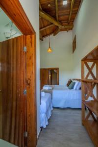 a bedroom with two beds and a staircase at Village das Estações in Marau