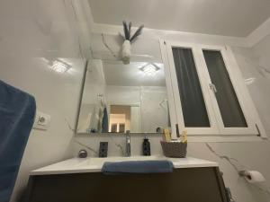 a bathroom with a sink and a mirror at B&B Kira Home in La Mura