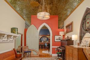 a living room with orange walls and a ceiling at Dancing Moon Luxury Loft and Event Space - Sleeps 12 in Oshkosh