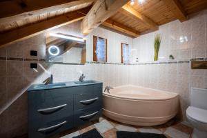 a bathroom with a tub and a sink and a toilet at Chalet Colenfrey - Valloire in Valloire +25 photos