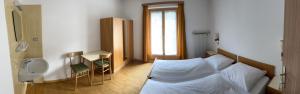 a bedroom with a bed and a sink and a toilet at Apartments Goller in Ortisei