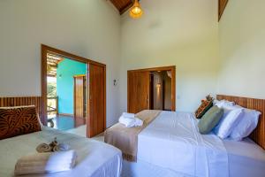 a bedroom with two beds with towels on them at Village das Estações in Marau