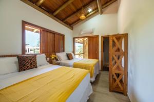 a bedroom with two beds and a window at Village das Estações in Marau +276 photos