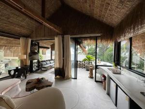 a living room with a couch and a table at Happy Coco Monkey - Cozy Studio by SP Villa in Ko Phangan