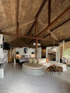 a living room with a couch and a table at Happy Coco Monkey - Cozy Studio By Sp Villa in Koh Phangan