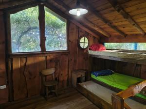 a room with a bed and a stool in a cabin at Cabaña Punta Mogotes in Mar del Plata