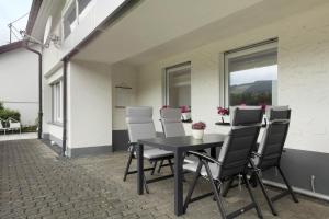 a black table and chairs on a patio at Schwalbennest in Lennestadt