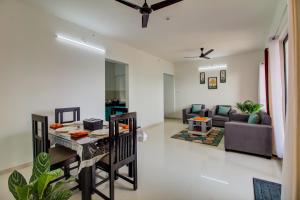 a living room with a table and a couch at VibeStayZ Kedar Hinjewadi in Hinjewadi +21 photos