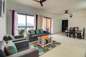a living room with two couches and a table at VibeStayZ Kedar Hinjewadi in Hinjewadi