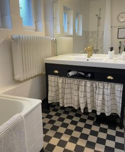 a bathroom with a sink and a tub and a mirror at The cozy family Retreat Lübeck in Lübeck +11 photos