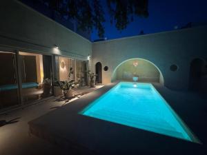 a swimming pool in the backyard of a house at night at Palazzo Giustiniani L'Ambasciatore in Sogliano Cavour +114 photos