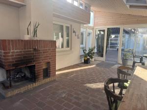 a patio with a brick fireplace and a table and chairs at Large central townhouse, only 500m from Horsens city center in Horsens
