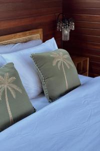 Ένα ή περισσότερα κρεβάτια σε δωμάτιο στο Umah Dedari