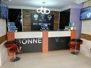 a bar in a restaurant with two chairs at Bonne Vie Hotel in 6th Of October +39 photos