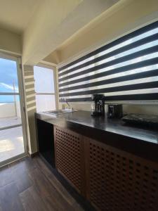 a kitchen with a counter with a sink and a window at MK BEACH Playa Del Carmen in Playa del Carmen +63 photos