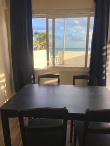 a table and chairs with a view of the beach at MK BEACH Playa Del Carmen in Playa del Carmen