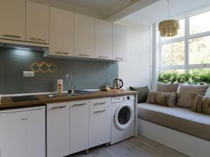 a kitchen with a washing machine and a window at Deluna Ümitköy Suite in Çayyolu