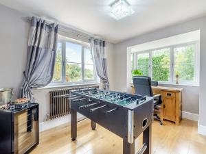a room with a ping pong table in it at Lovetts Bridge Cottage in Atherstone