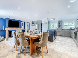 a kitchen with a wooden table and chairs at Lovetts Bridge Cottage in Atherstone +17 photos