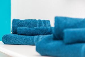 a pile of blue towels sitting on a table at Casa vacanze “Genna ‘e su Monte” in Baunei
