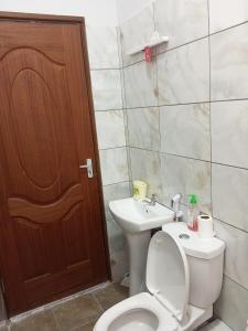 a bathroom with a toilet and a sink at Blessing homes in Mombasa +7 photos
