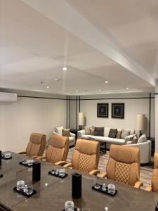a large room with a table and chairs and a couch at Tulip View Hotel in Khamis Mushayt