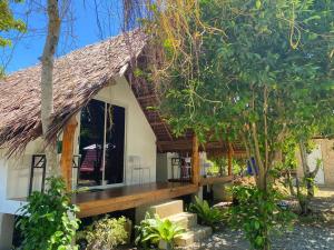 a house with a thatched roof and a wooden deck at RCM Ecolodge Inn in San Juan +45 photos
