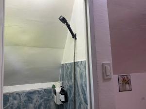 a shower with a light in a bathroom at RCM Ecolodge Inn in San Juan