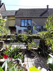 a house with a garden in front of it at Ferienwohnung Eifelzauber in Willwerscheid +16 photos