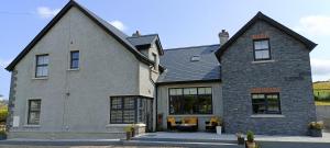 a large gray house with a black roof at Gateside Lodge in Portrush