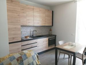 a kitchen with a sink and a table in a room at Suite Petit in Vairano Scalo