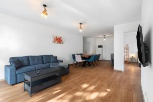 a living room with a blue couch and a table at White House Apartments-App 1 und 2 in Kappel-Grafenhausen
